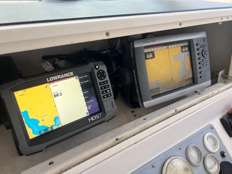Slide: The Image of Dual marine GPS displays on a 1997 Pro-Line 2810 Walkaround boat dashboard. - 9