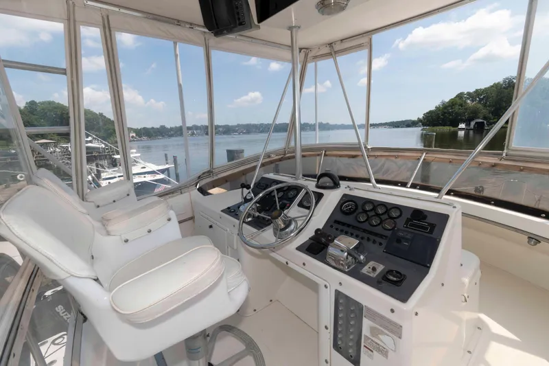 Slide: The Image of 1989 Tiara Yachts 36 Convertible helm with scenic waterfront view. - 3