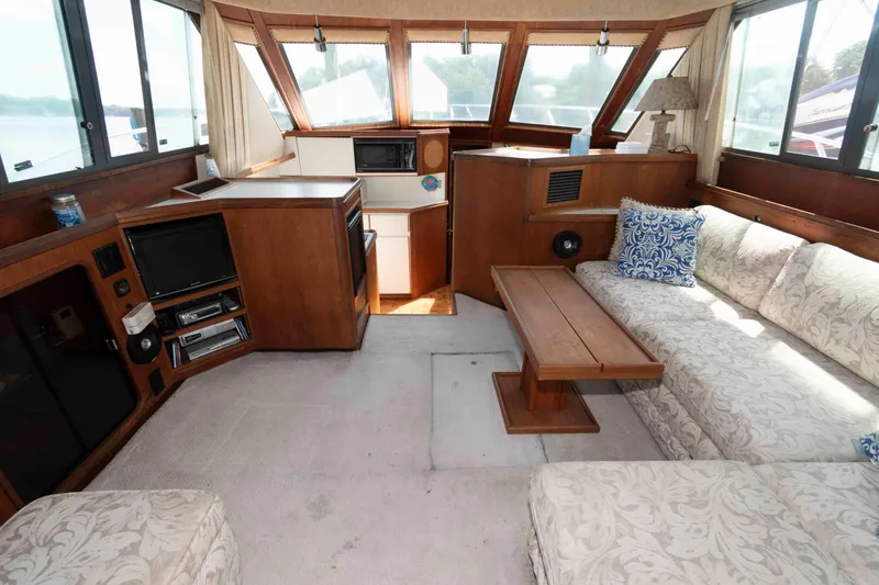Slide: The Image of Interior of 1989 Tiara Yachts 36 Convertible with cozy seating and wooden accents. - 7