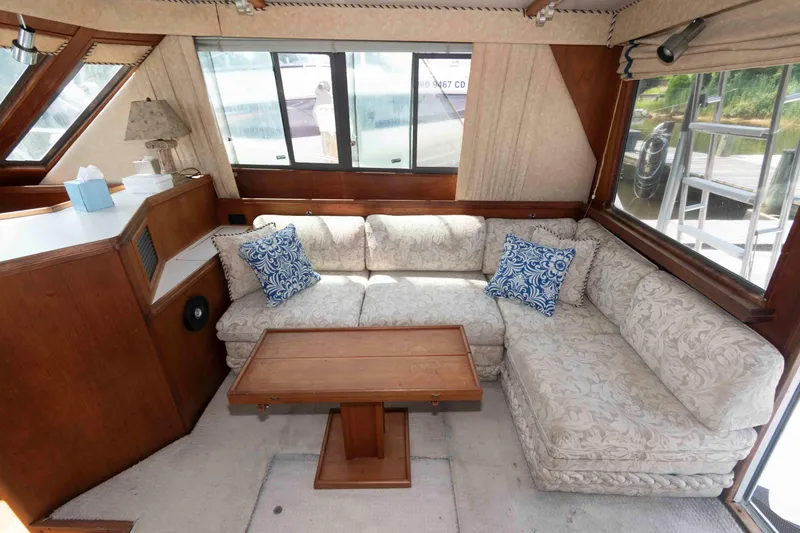 Slide: The Image of Interior of 1989 Tiara Yachts 36 Convertible with cozy seating and wooden table. - 8