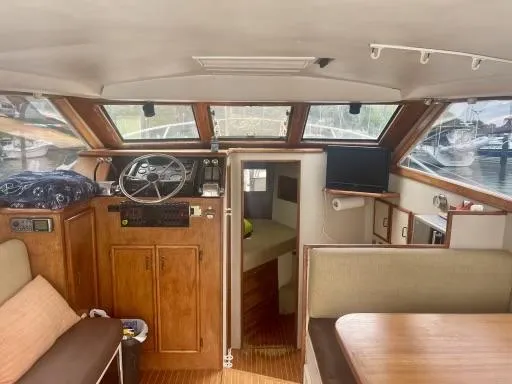 Slide: The Image of Interior of 1990 Ocean Yachts 29 Super Sport, featuring helm, seating, and cabin area. - 2