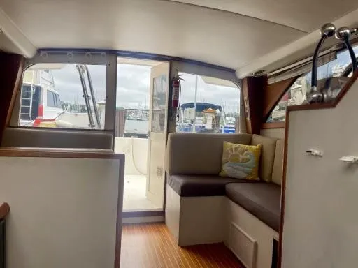Slide: The Image of Interior of 1990 Ocean Yachts 29 Super Sport, featuring seating and marina view. - 3
