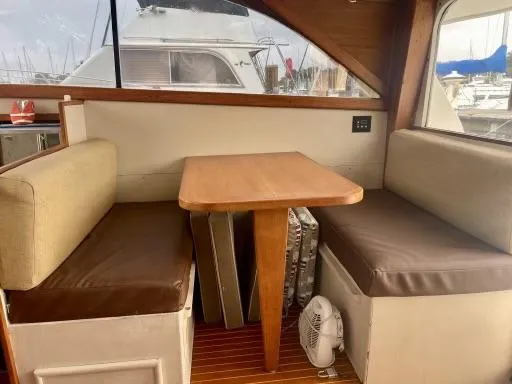 Slide: The Image of Interior of 1990 Ocean Yachts 29 Super Sport with dining area and cushioned seating. - 4