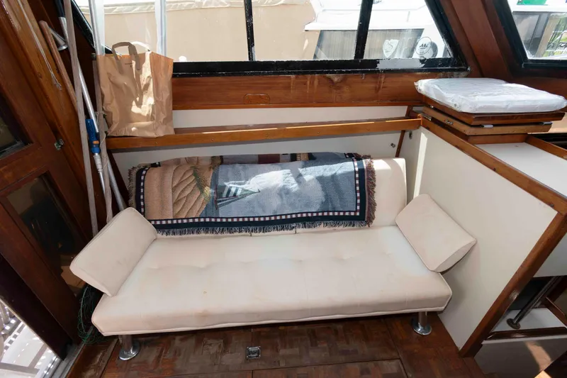 Slide: The Image of Cozy interior of 1986 Shannon Brendan 32 boat with cushioned seating and nautical decor. - 12