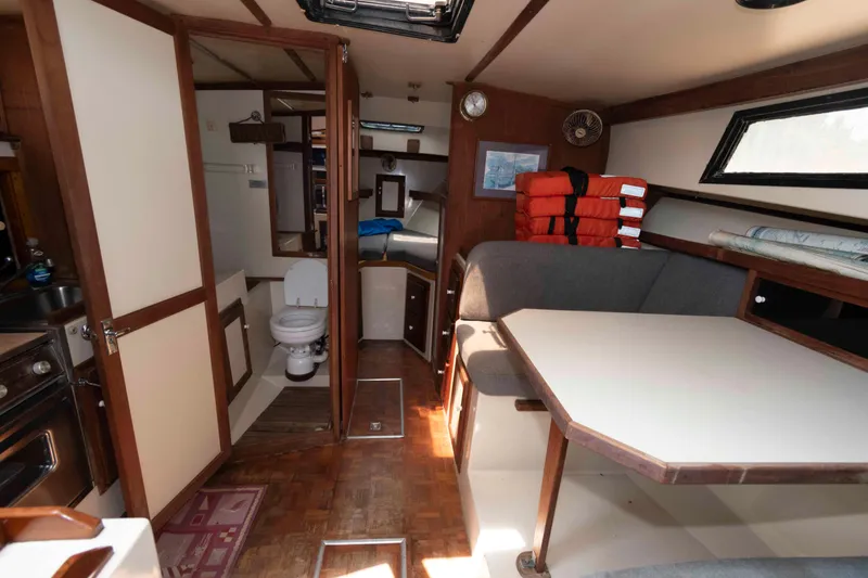 Slide: The Image of Interior of 1986 Shannon Brendan 32 boat with dining area, toilet, and life jackets. - 14