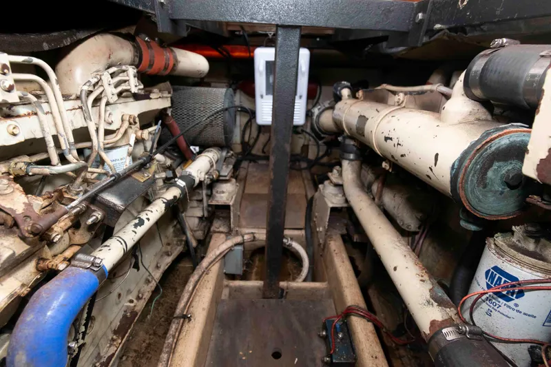 Slide: The Image of Engine room of a 1986 Shannon Brendan 32 boat, showcasing mechanical components and piping. - 17
