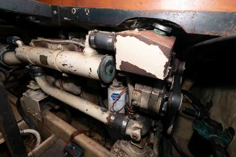 Slide: The Image of Engine compartment of a 1986 Shannon Brendan 32 boat, showing mechanical components and pipes. - 18
