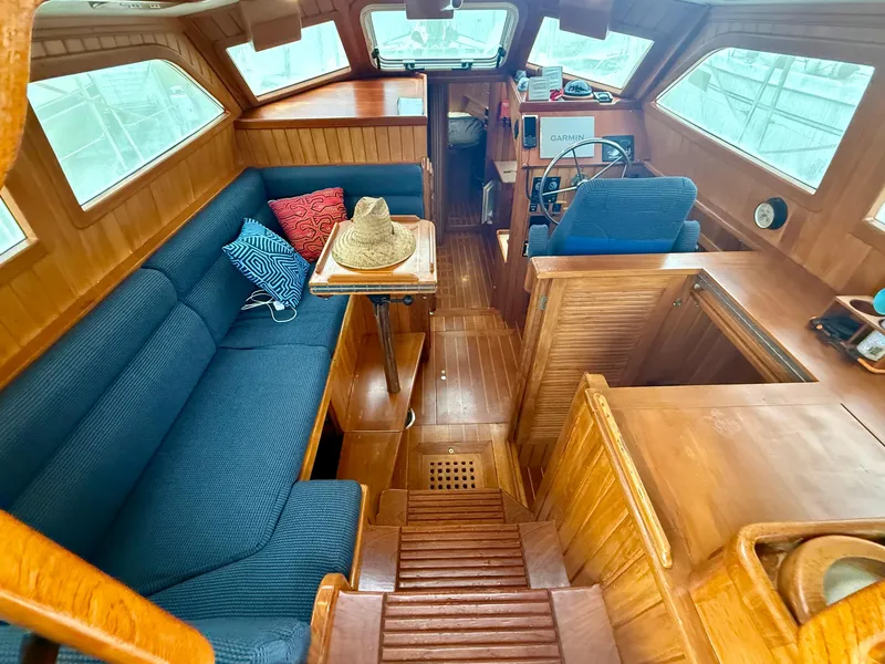 Slide: The Image of Interior of 2005 Cabo Rico 42 Pilot yacht with wooden finish and blue seating. - 3