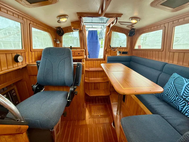 Slide: The Image of Interior of 2005 Cabo Rico 42 Pilot yacht with wood finish and blue seating. - 4
