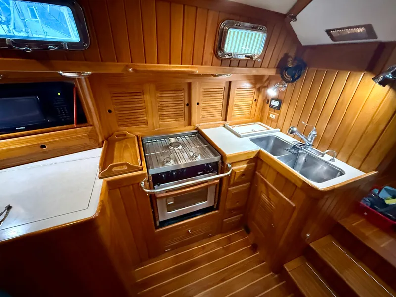 Slide: The Image of Luxurious wooden galley interior of 2005 Cabo Rico 42 Pilot yacht with stove and sink. - 6