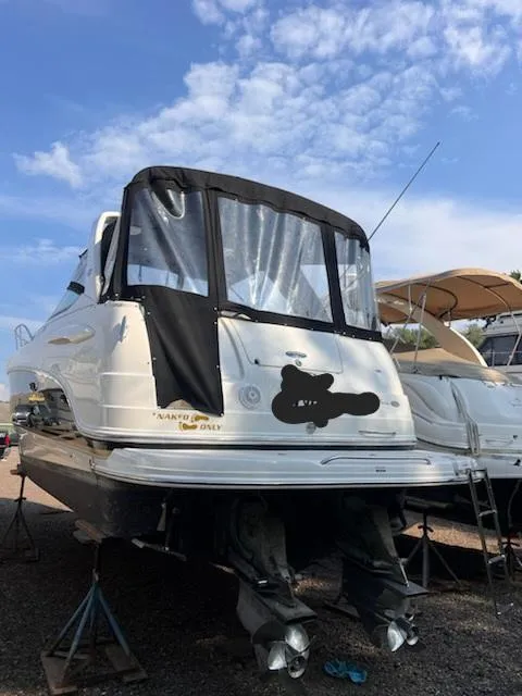 Slide: The Image of 2005 Chaparral 270 Signature boat on stands, rear view, with black canvas cover. - 2