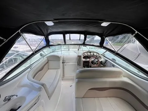 Slide: The Image of 2005 Chaparral 270 Signature boat interior with seating and helm under black canopy. - 9