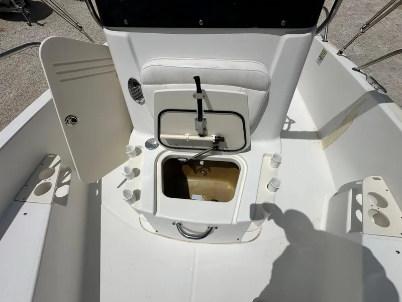Slide: The Image of Boston Whaler 200 Dauntless 2010 boat interior with open storage compartment and cup holders. - 10
