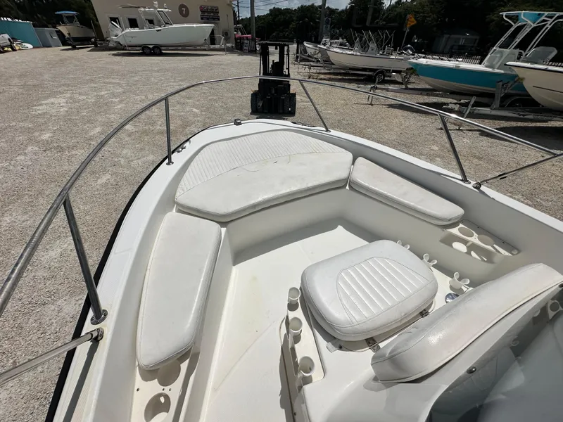 Slide: The Image of 2010 Boston Whaler 200 Dauntless boat interior with white seating and railings. - 11
