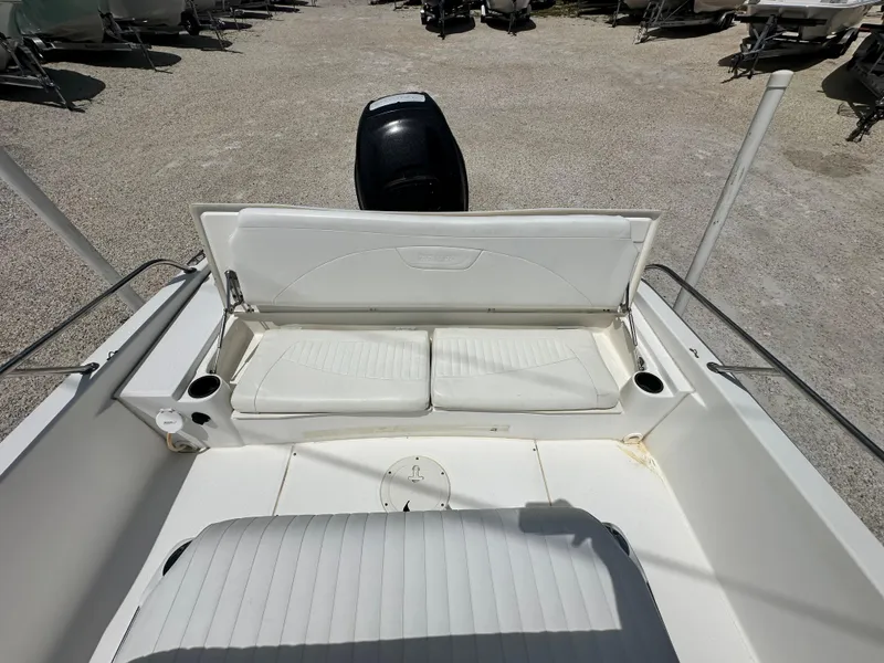Slide: The Image of 2010 Boston Whaler 200 Dauntless boat interior with white seating and cup holders. - 12