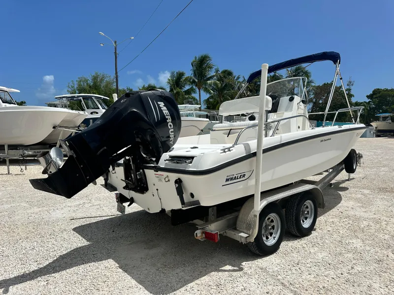 Slide: The Image of 2010 Boston Whaler 200 Dauntless boat on trailer with Mercury outboard motor. - 3