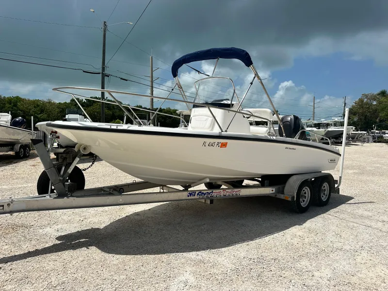 Slide: The Image of 2010 Boston Whaler 200 Dauntless boat on trailer under cloudy sky. - 7