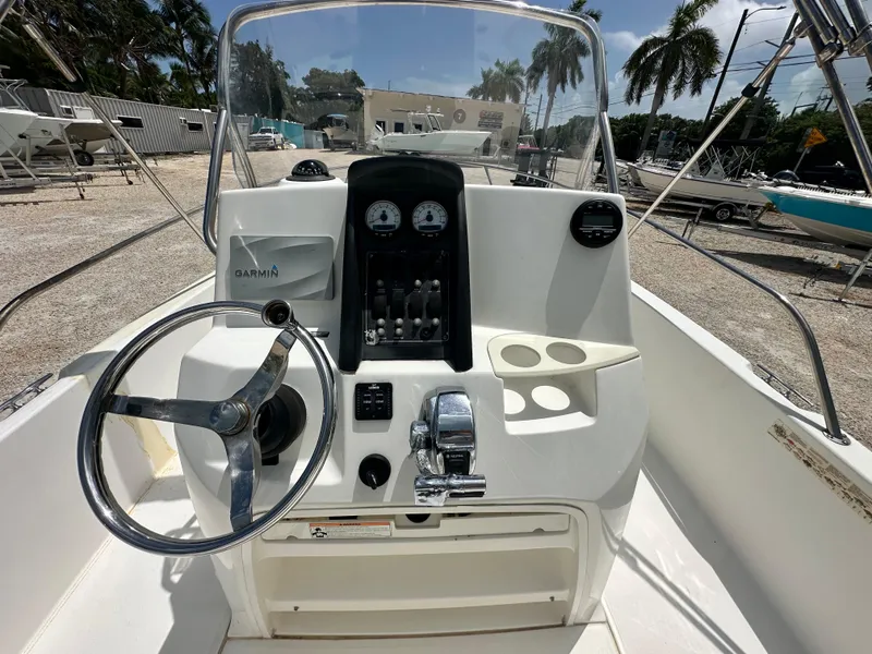 Slide: The Image of 2010 Boston Whaler 200 Dauntless boat console with steering wheel and Garmin navigation system. - 8