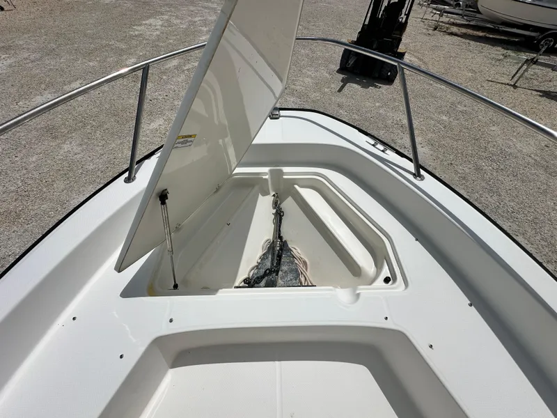 Slide: The Image of 2010 Boston Whaler 200 Dauntless anchor storage compartment open on deck. - 9