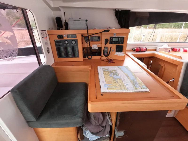 Slide: The Image of Navigation station on 2013 Nautitech 442 catamaran with chart and control panel. - 10