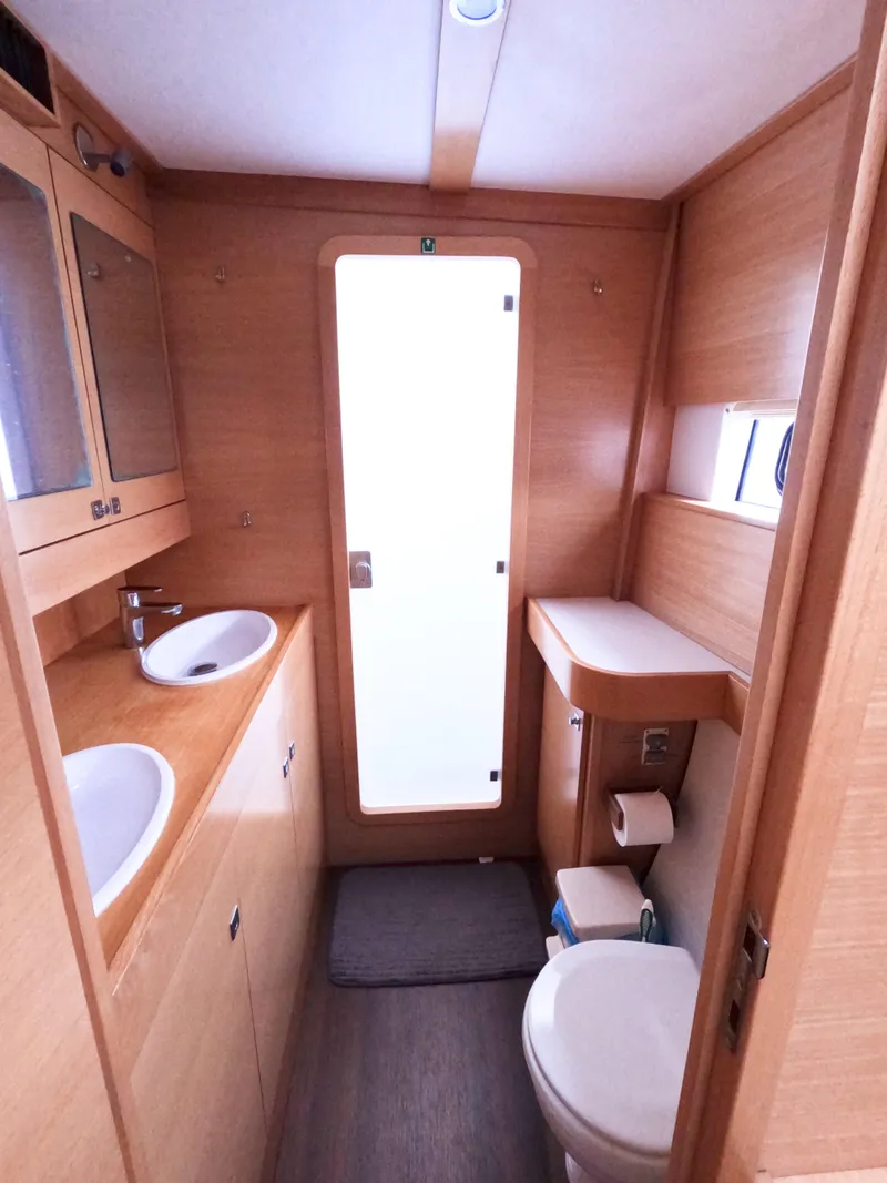 Slide: The Image of 2013 Nautitech 442 yacht bathroom with dual sinks, wooden cabinetry, and modern fixtures. - 7