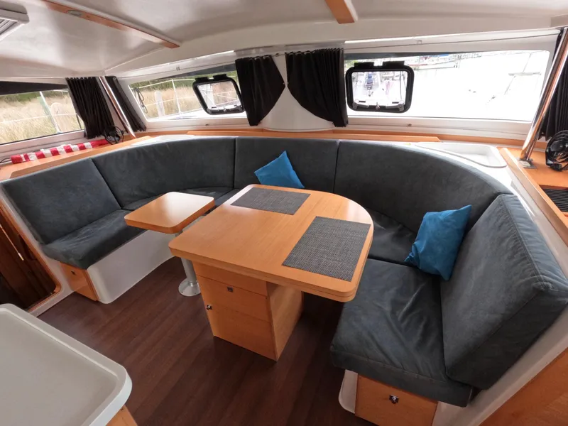 Slide: The Image of Interior of 2013 Nautitech 442 catamaran with cozy seating and wooden table. - 9
