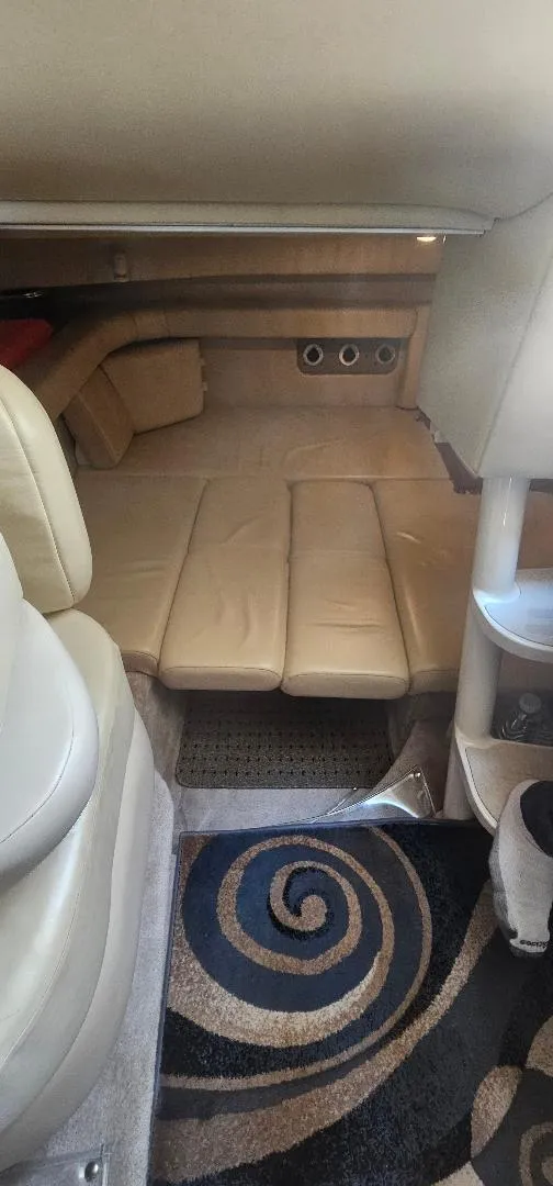 Slide: The Image of Interior of 2002 Regal Commodore 3060 boat with beige seating and spiral-patterned carpet. - 11