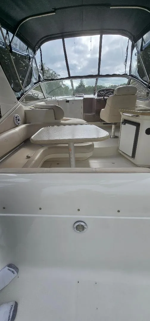 Slide: The Image of 2002 Regal Commodore 3060 boat interior with seating and table. - 2