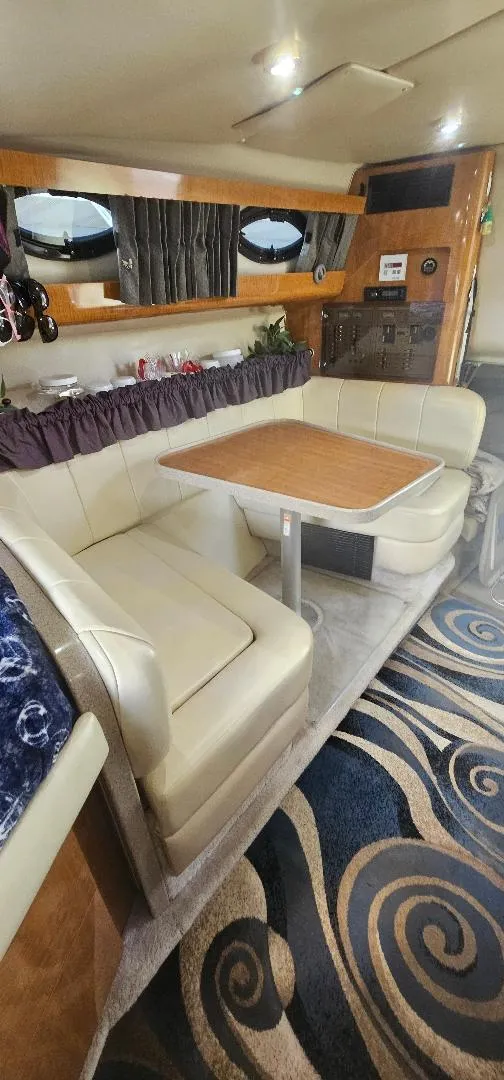 Slide: The Image of Interior of 2002 Regal Commodore 3060 yacht with plush seating and elegant decor. - 4