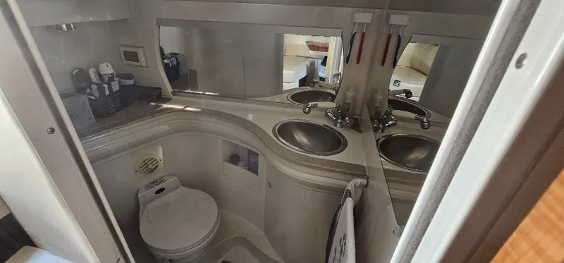 Slide: The Image of Bathroom interior of 2002 Regal Commodore 3060 yacht with dual sinks and mirrors. - 5