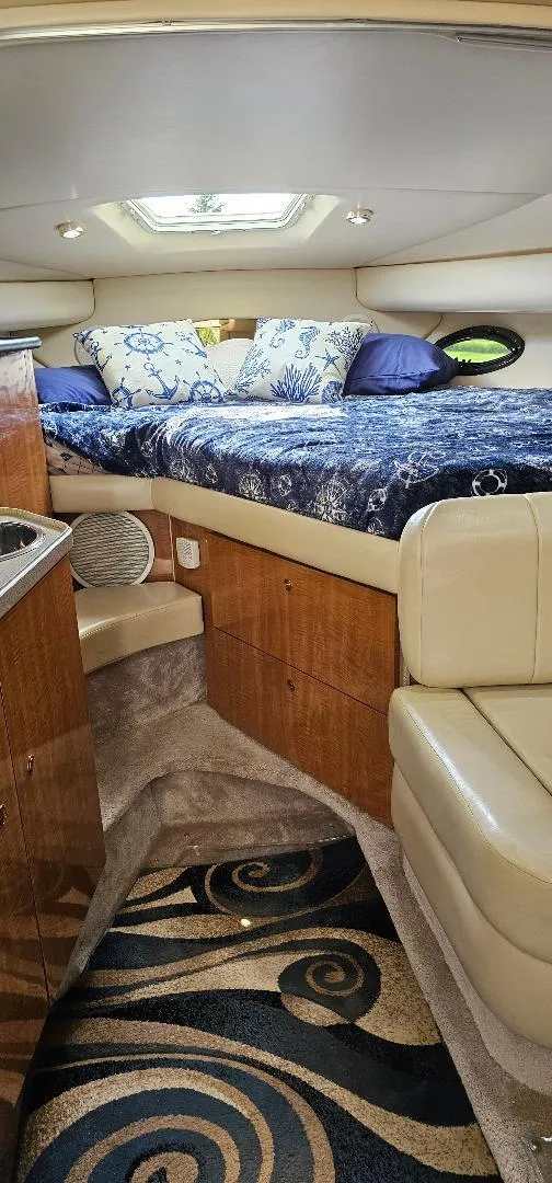 Slide: The Image of Luxurious interior of 2002 Regal Commodore 3060 yacht with cozy bed and elegant decor. - 7