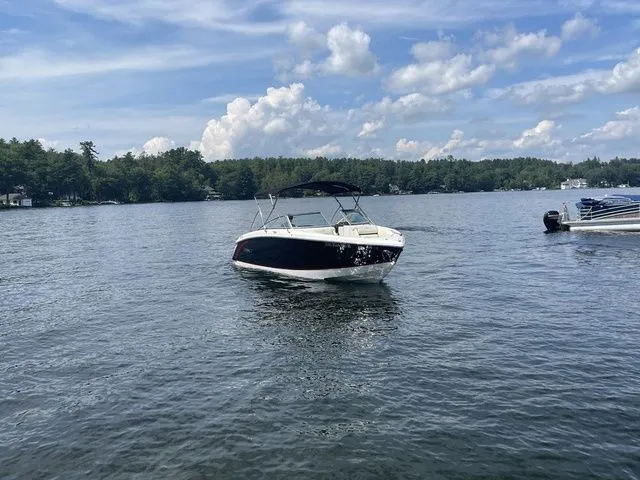 Slide: The Image of 2019 Cobalt R5 boat on a serene lake under a partly cloudy sky. - 11
