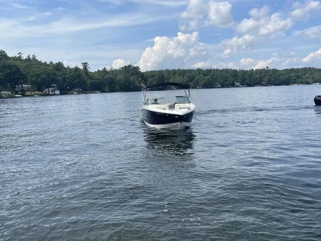 Slide: The Image of 2019 Cobalt R5 boat on a serene lake under a partly cloudy sky. - 12