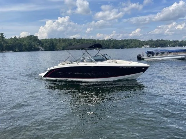 Slide: The Image of 2019 Cobalt R5 boat cruising on a lake under a partly cloudy sky. - 13