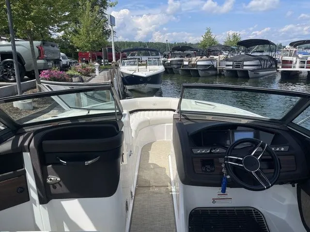 Slide: The Image of 2019 Cobalt R5 boat interior at marina, surrounded by parked boats and vehicles. - 15