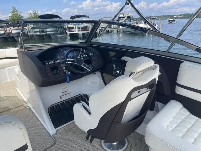 Slide: The Image of 2019 Cobalt R5 boat interior with steering wheel, white seating, and lake view. - 16