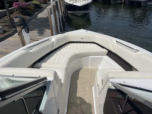 Slide: The Image of 2019 Cobalt R5 boat with white seating, docked by a wooden pier. - 18