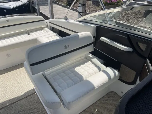 Slide: The Image of 2019 Cobalt R5 boat interior with white cushioned seating and sleek design. - 21