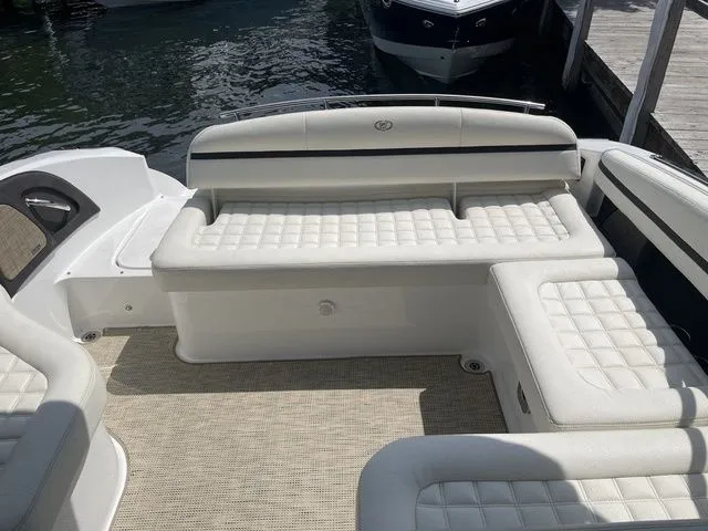 Slide: The Image of 2019 Cobalt R5 boat interior with white cushioned seating and water in the background. - 23