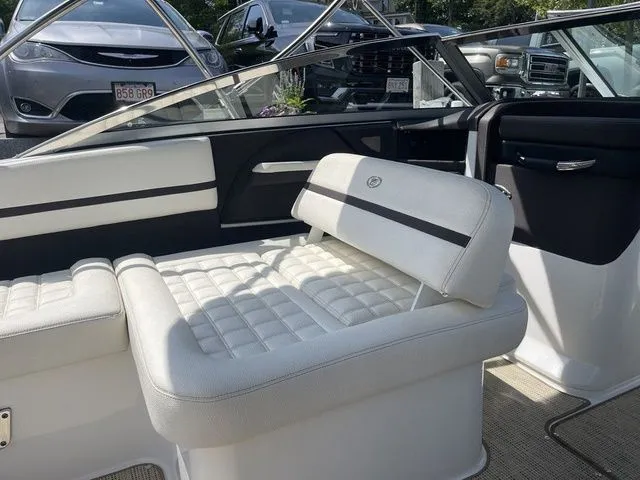 Slide: The Image of 2019 Cobalt R5 boat interior with white cushioned seating and sleek design. - 26