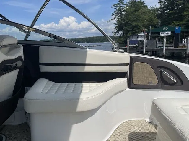 Slide: The Image of 2019 Cobalt R5 boat interior with white seating, dockside view, and clear blue sky. - 28