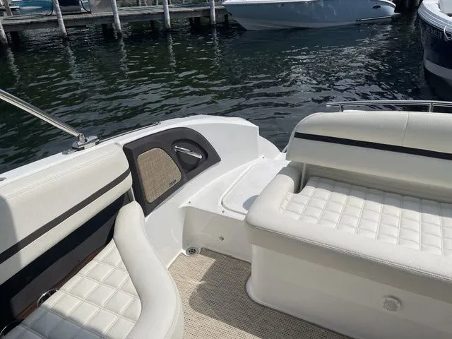 Slide: The Image of 2019 Cobalt R5 boat interior with white seating, docked by the water. - 29