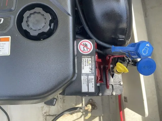 Slide: The Image of Engine compartment of a 2019 Cobalt R5 boat with warning labels and maintenance caps. - 34