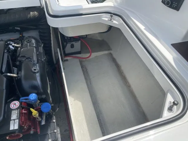 Slide: The Image of Engine compartment of a 2019 Cobalt R5 boat, showcasing storage space and engine components. - 35