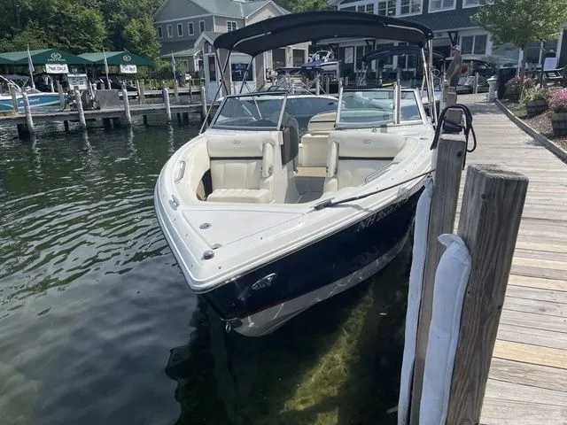 Slide: The Image of 2019 Cobalt R5 boat docked at a marina with scenic waterfront view. - 36