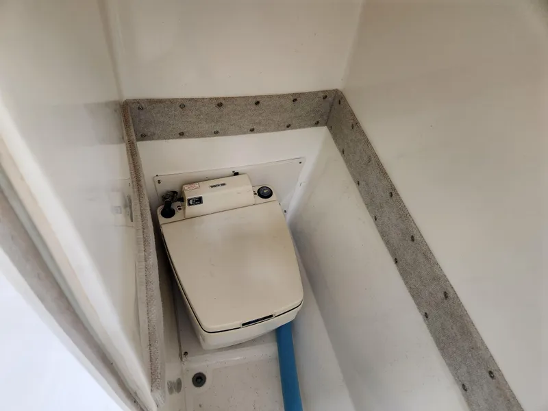 Slide: The Image of Boat interior with a compact toilet in a 2000 World Cat 266 Leisure Cat. - 20