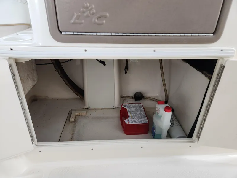 Slide: The Image of Storage compartment of a 2000 World Cat 266 Leisure Cat boat with cleaning supplies. - 21