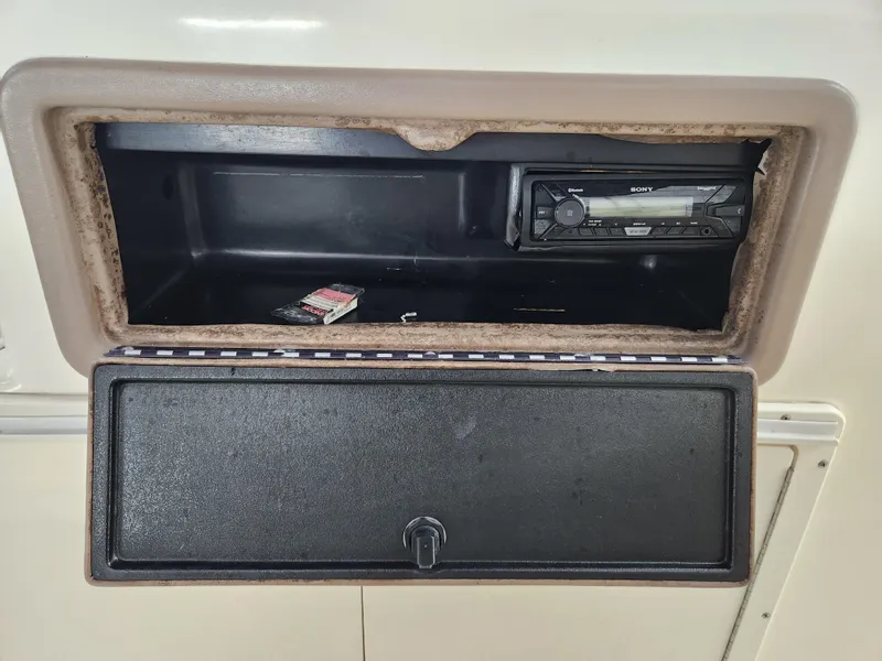 Slide: The Image of Open storage compartment with Sony stereo in a 2000 World Cat 266 Leisure Cat boat. - 22