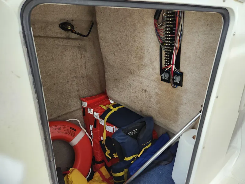 Slide: The Image of Storage compartment of a 2000 World Cat 266 Leisure Cat with life jackets and safety equipment. - 23