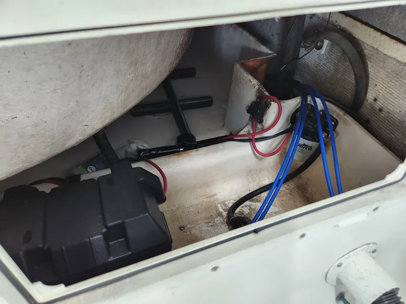 Slide: The Image of Engine compartment of a 2000 World Cat 266 Leisure Cat boat, showing wiring and components. - 28